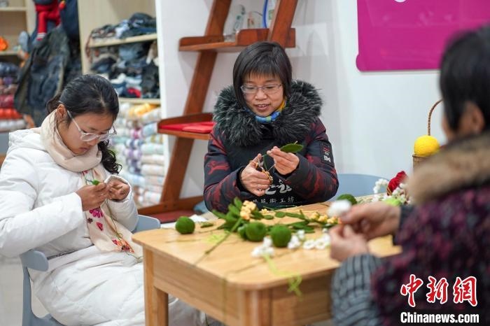 文創(chuàng)工作室的姐妹們正在鉤織月桂葉片。　古良駒 攝