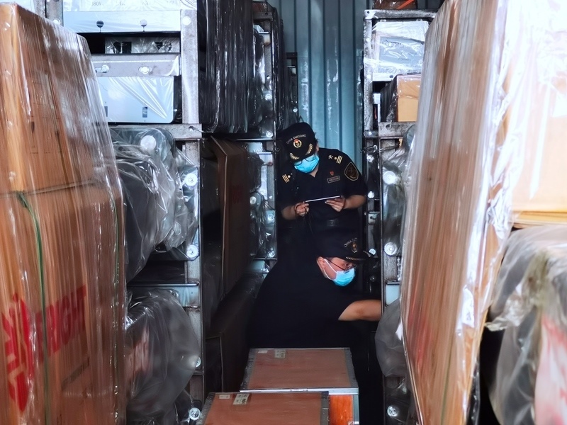 關(guān)員利用工業(yè)內(nèi)窺鏡在集裝箱內(nèi)進(jìn)行查驗(yàn)。人民網(wǎng)記者 栗翹楚攝