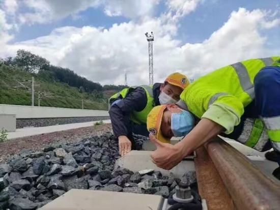 佟郎（左）正在檢修鐵路。受訪者供圖