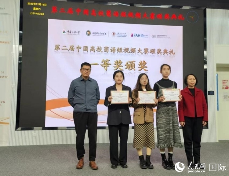 澳門大學中葡雙語教學暨培訓中心主任姚京明（左一）和中國傳媒大學外國語言文化學院院長文春英（右一）為一等獎獲得者頒獎。人民網(wǎng)記者 魯揚攝