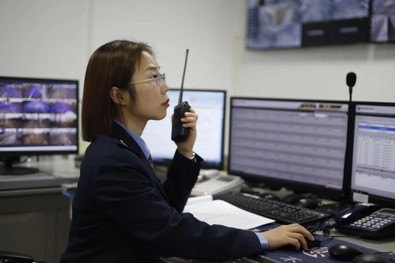 張華正在使用對(duì)講機(jī)溝通客運(yùn)工作情況。蔡紫妍攝