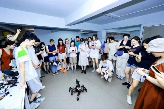 8月25日，中外青年在浙江杭州觀看機(jī)器人表演。新華社發(fā)（清華大學(xué)供圖）