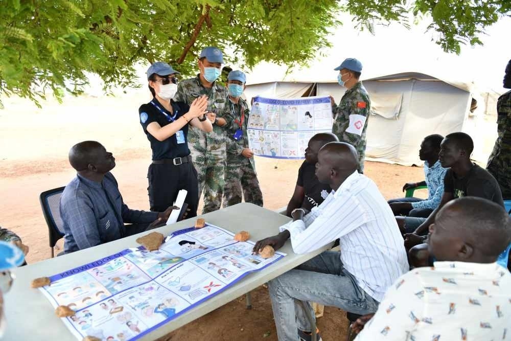 2020年3月，在南蘇丹首都朱巴，執(zhí)行聯(lián)合國維和任務(wù)的中國維和警察廖潔給當(dāng)?shù)鼐熘v解防疫知識。