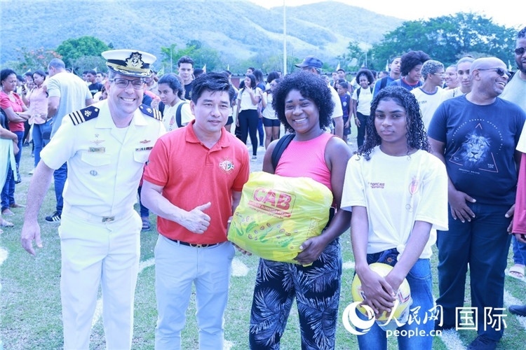 巴西中國浙江商會會長鄭俠茂向巴西貧困社區(qū)兒童及家庭捐贈基礎(chǔ)食品籃子和足球。人民網(wǎng)記者陳海琪 攝