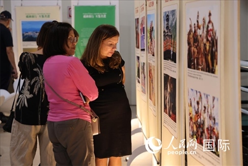 圖為當(dāng)?shù)赜^眾在圖片展現(xiàn)場(chǎng)欣賞作品，張志文攝