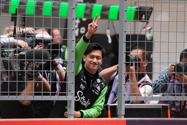 2024年4月19日，索伯車隊中國車手周冠宇（中）在練習(xí)賽前向觀眾致意。當(dāng)日，F(xiàn)1中國大獎賽在上海開賽。中國車手周冠宇主場首秀參賽。新華社記者 夏一方攝